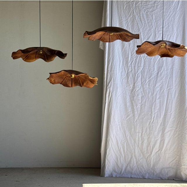 Very large flat, undulating leaf pendant light in teak with a floral, striated pattern. Elegant and decorative, organic...