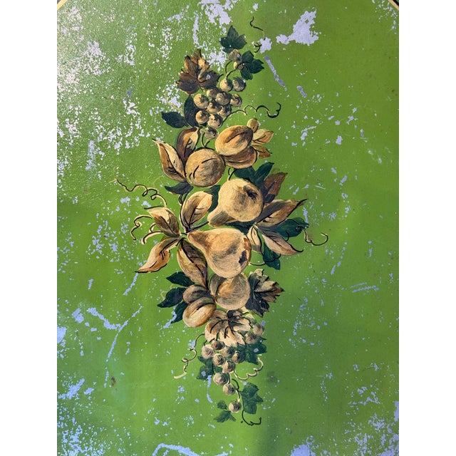 This is an antique octagonal toleware tray. It has hand painted fruit motifs. It has a hand painted gold lining as well....