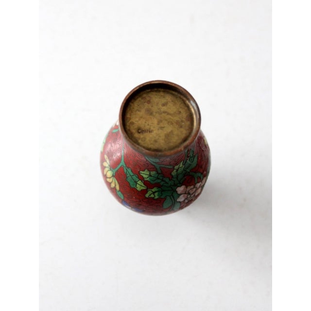 This vintage Chinese cloisonné vase features a graceful baluster form and richly enameled floral decoration set against a...