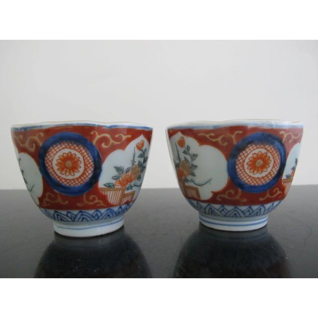 Lovely Japanese Imari porcelain cup or bowl set with red, blue, green, and gold floral design. Each measures 2 1/2" tall x...