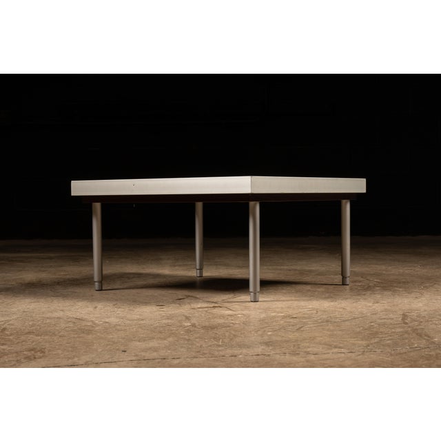 Vintage square coffee table with a brushed aluminum body. This piece, minimalist in design, features a recessed central...