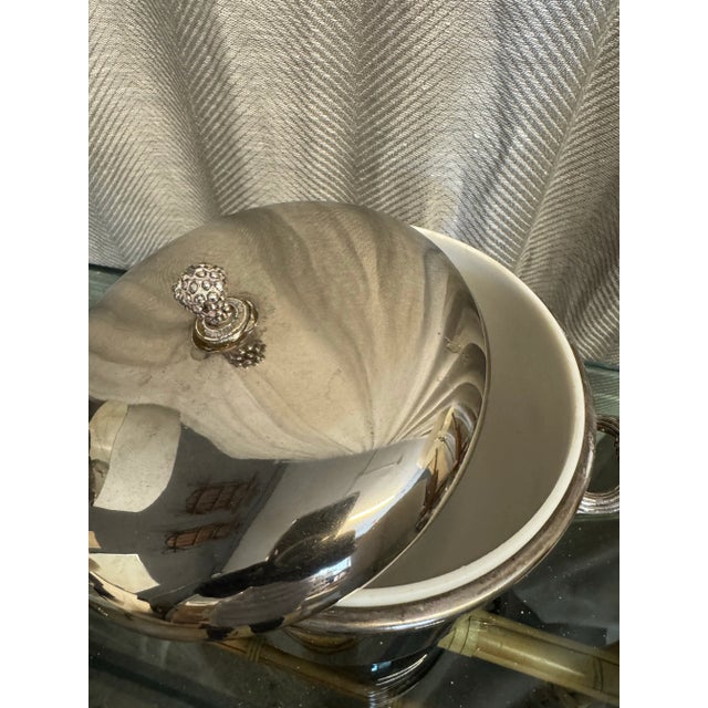 Silver plate vintage 1970s ice bucket with pinecone lid detail with white bakelite insert. Manufactured by International...
