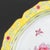 Pair of Chinese Floral Motif Enameled Plates, each hand-painted with peony flowers and a butterfly within yellow border...