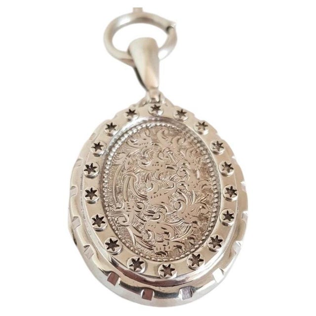 A charming late Victorian sterling silver oval locket and chain dating to circa the 1880s, designed in the distinctive...