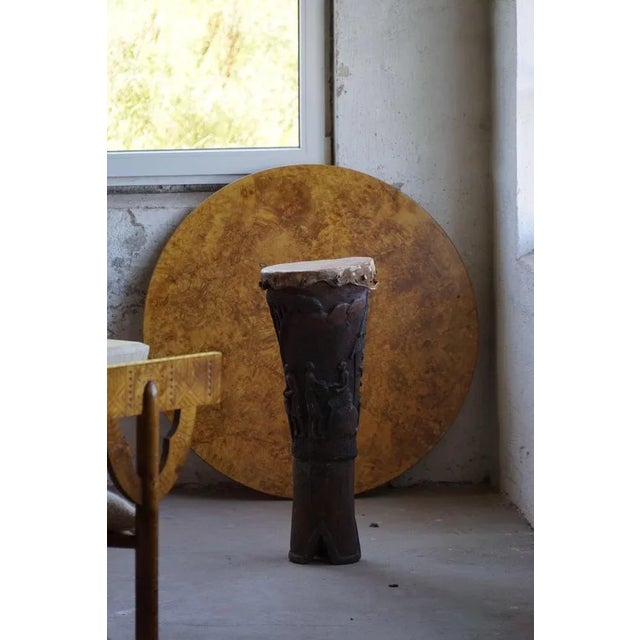 An organic, hand-carved wooden drum from West Africa, dating to the 1950–1960s. Crafted from solid wood, this piece...
