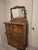 This is a Victorian-era serpentine highboy dresser crafted from quarter-sawn "tiger" oak, featuring a carved crest and a...
