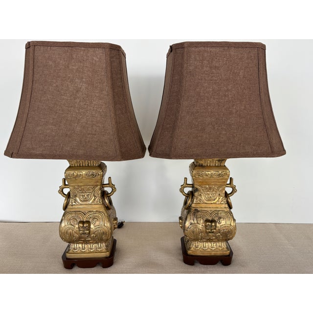 Pair of vintage 1950s, Asian-flavor table Lamps made from large archaic-style cast brass Urns mounted on hand carved...