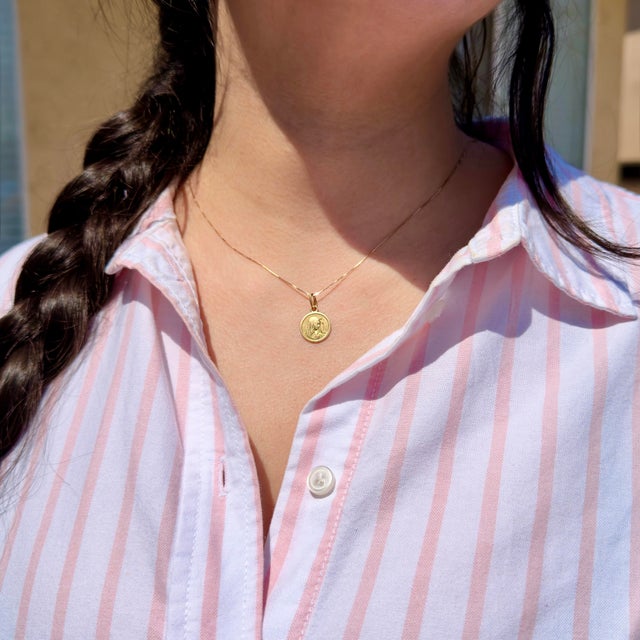 About This Pendant: A cherished religious piece circa 1960s, this Italian 18K Virgin Mary medallion carries the warmth of...