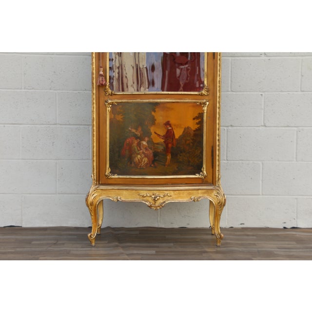 Beautiful antique French Louis XV-style curio cabinet / vitrine featuring elegant hand-carved details, gold leaf accents,...