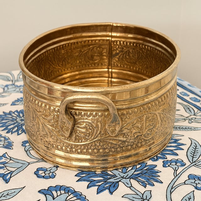 Solid brass oval bowl made in India featuring richly embossed floral and foliate motifs and a striking pair of...