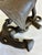 A weighty cast iron bell mounted on an anchor-form base, detailed with cast rope trim along the shank and arms and...