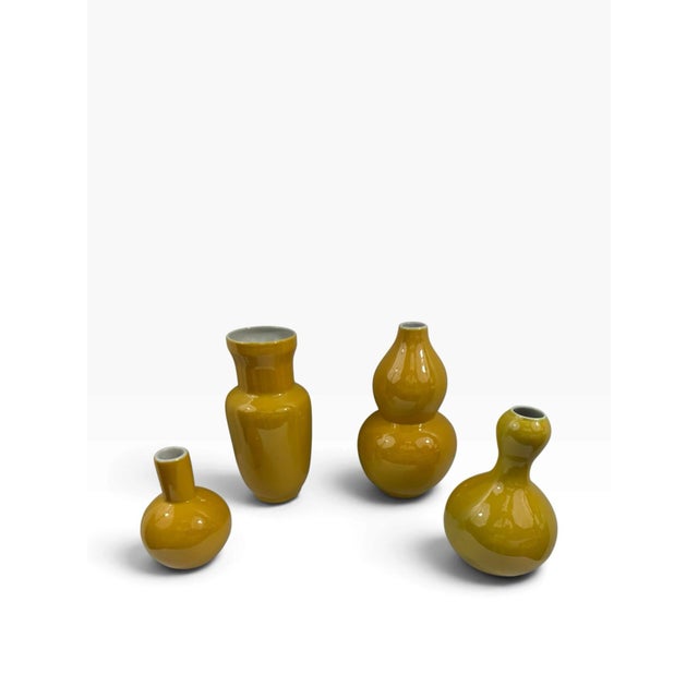 For sale is a matched set of four Chinese porcelain vases finished in a rich mustard-yellow (imperial yellow style)...