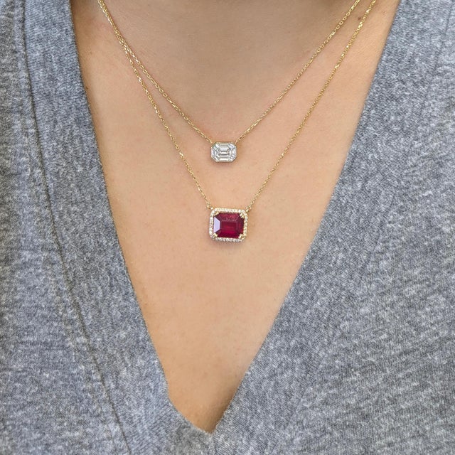 Rich ruby center framed by a dazzling halo of natural diamonds, crafted in solid 14K gold for timeless sophistication....