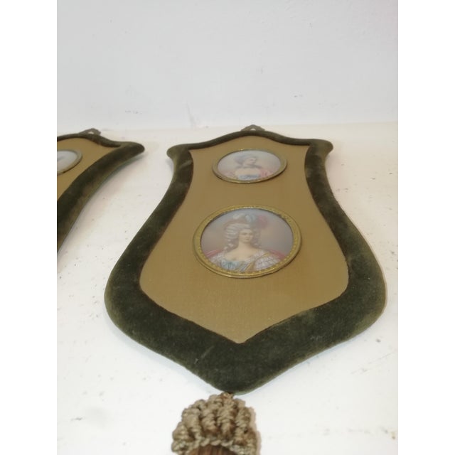 A pair of green velvet frames with a decorative tassel. Two curved glass ovals for each vortex. Hand-painted figures in...