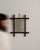 Here is a mirror, its natural faux-bamboo frame, hanging chain the first thing to catch the eye. It was made in France...