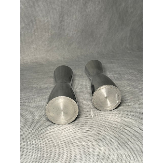 Set of two minimalist,contemporary design candle holders in heavy steel. This piece is attributed to the mentioned...