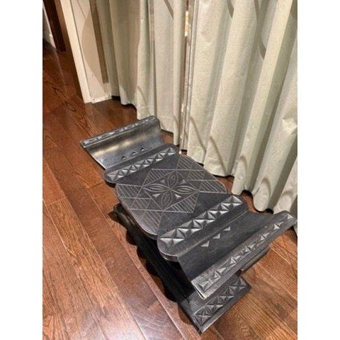 Exceptional ottoman hand carved from Sese wood in the style of regal Ashanti thrones. Cushion included.