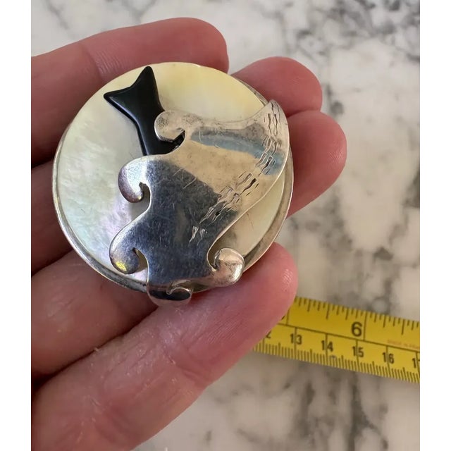 Lovely hand made sterling silver and mother of pearl fish in wave brooch with artist markings. A uniquely designed piece.