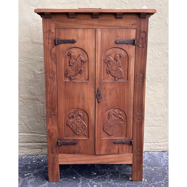 About the Item Spanish Gothic Style Walnut wardrobe with Five hangers and carvings The doors features heads and symbols...