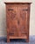 About the Item Spanish Gothic Style Walnut wardrobe with Five hangers and carvings The doors features heads and symbols...