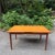This Mid-Century Modern teak dining table features the clean lines and warm wood grain that define Scandinavian design....