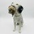 This rare handsome antique porcelain figure depicts a hunting dog, likely an English setter, captured mid hunt. Decorated...