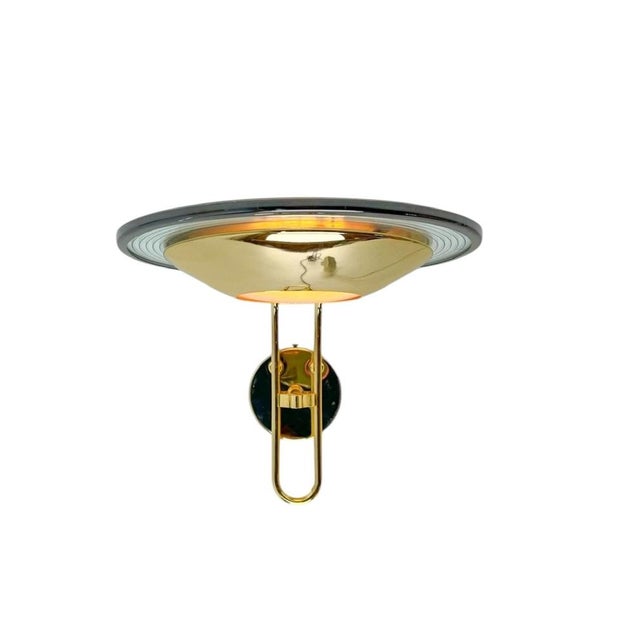 Vintage disc-shaped Brass and Glass Italian wall lamp with subtile concentric detailing, beautiful paired with with a...