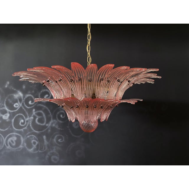 Luxury and genuine murano glass chandelier. Hand made in murano. It made by 58 murano pink glasses in a gold metal frame....