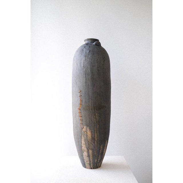 Amphoreus Vase in Stoneware, Metallic Stitches & Oxidized Iron by Robin Kerr Unique Piece Dimensions: D 21 x W 21 x H 72...