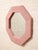 A wonderfully playful vintage wall mirror with a bold octagonal silhouette and an unexpected soft pink textile-wrapped...