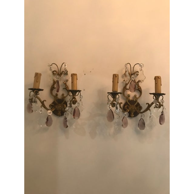 These beautiful 1920's brass sconces have decorative scrolls with acanthus leaves and an acorn finial at the base. The 2...