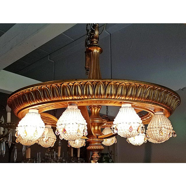 Unique, French Louis XVI bronze doré wheel chandelier, featuring lovely patina on the gold gilding and ten under-mount...