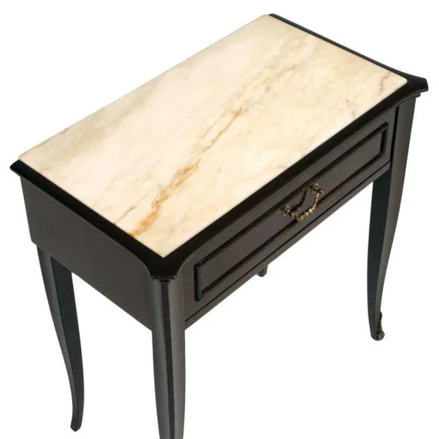 This mid-century nightstand is reminiscent of designs by Cesare Lacca. The table features a lacquered mahogany structure...