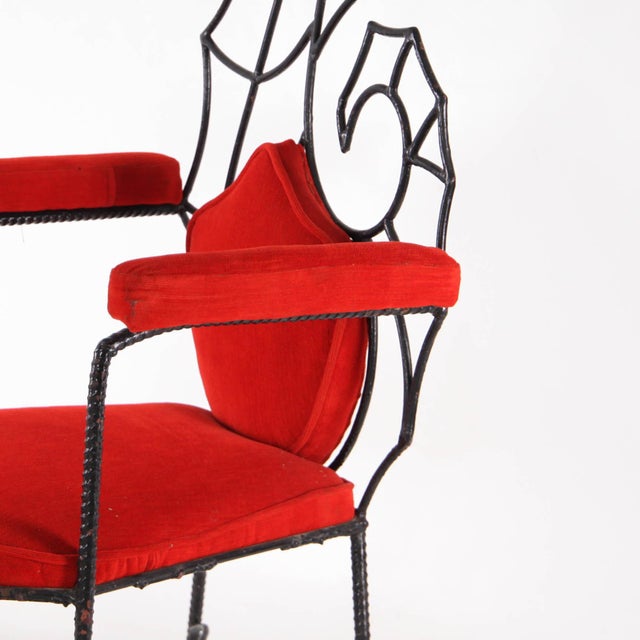 Beautiful vintage armchair in blackened iron depicting a seahorse. Upholstered in red velvet, this armchair captivates...