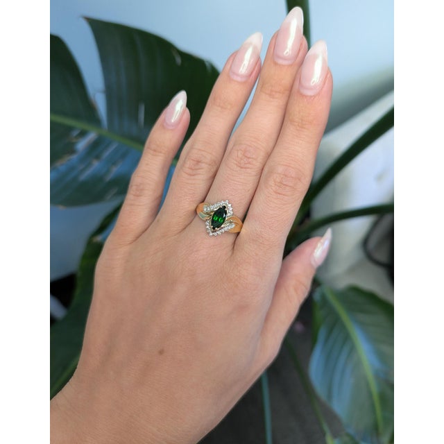 A 1.1Ct chrome diopside ring set in solid 10K gold, accented with sparkling earth-mined diamonds for a refined, natural...