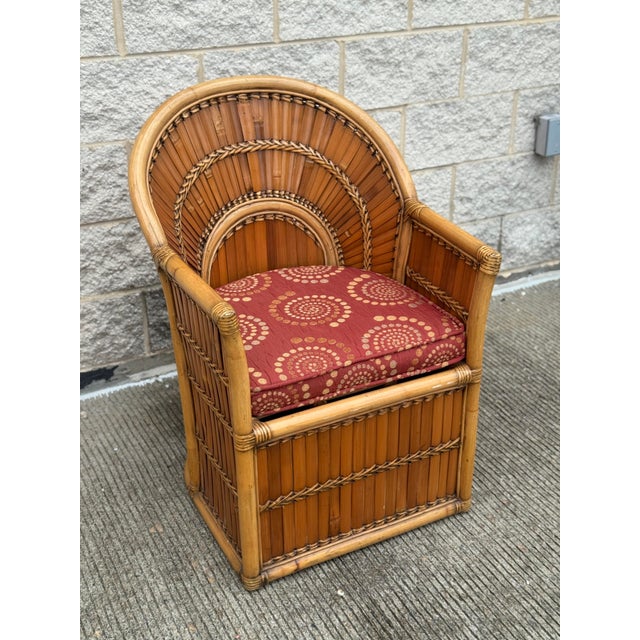 Patio lounge chair made from woven split bamboo, the back in a fan arrangement, with removable seat cushion.