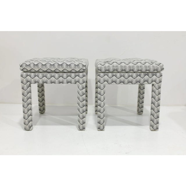 Enhance your living space with this great looking pair of pillow top ottomans newly upholstered in a Kelly Wearstler...