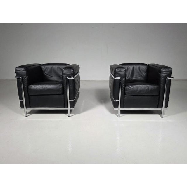 A pair of lc2 “grand confort, petit modèle” armchairs, designed in 1928 by le corbusier, pierre jeanneret and charlotte...