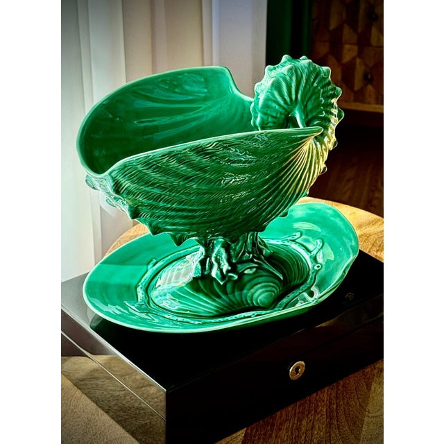 A sculptural Wedgwood nautilus shell comport with original underplate, dating to the 1930s. The rich green glaze and...