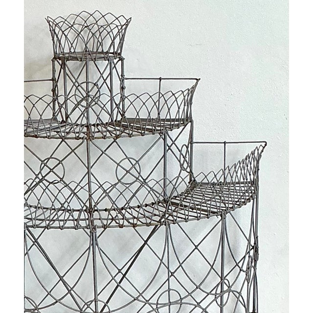 Add a touch of architectural elegance to your garden or sunroom with this magnificent vintage wrought iron plant stand....