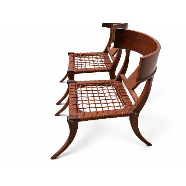 A striking set of six custom-made Klismos dining chairs with a warm walnut finish. Each chair pairs a broad, gently curved...