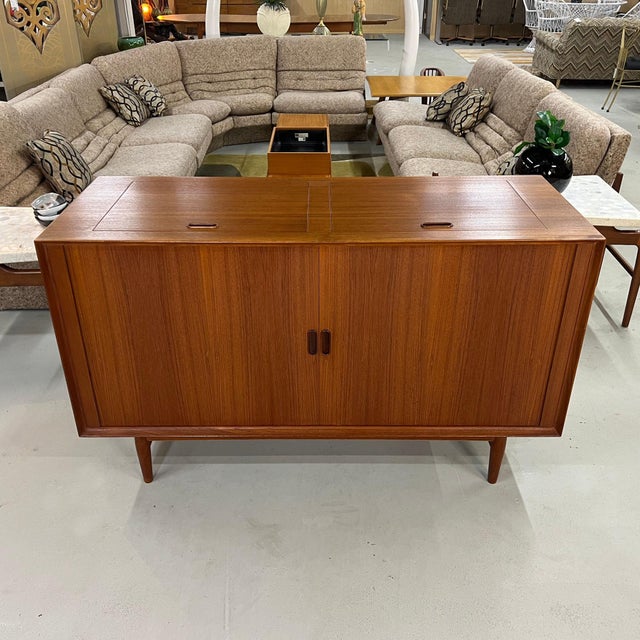 A striking record and stereo console designed by Arne Vodder for Sibast Møbler, Denmark, crafted in rich teak and bearing...