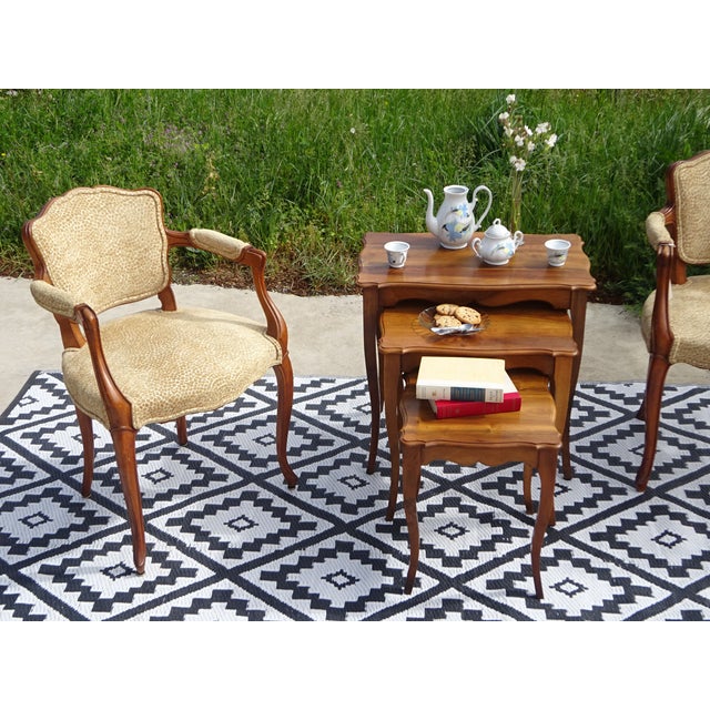 Set of 3 nesting tables all in solid walnut. Rectangular shaped tops, scalloped contours and chamfered edges. Arched base,...