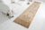 This is a vintage Turkish Oushak rug from the Mid 20th Century. The piece was hand-knotted.