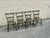 Charming set of four antique American painted wood side chairs featuring a rich ground with hand-painted floral decoration...
