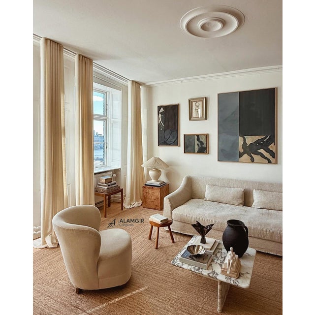 This handwoven natural jute rug features a clean rectangular shape with a subtle geometric pattern created through...