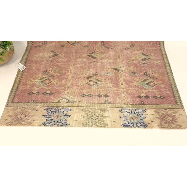 This vintage hand-knotted area rug is a semi-antique vintage area rug. The '70s Eastern Anatolian region's unique rug is...