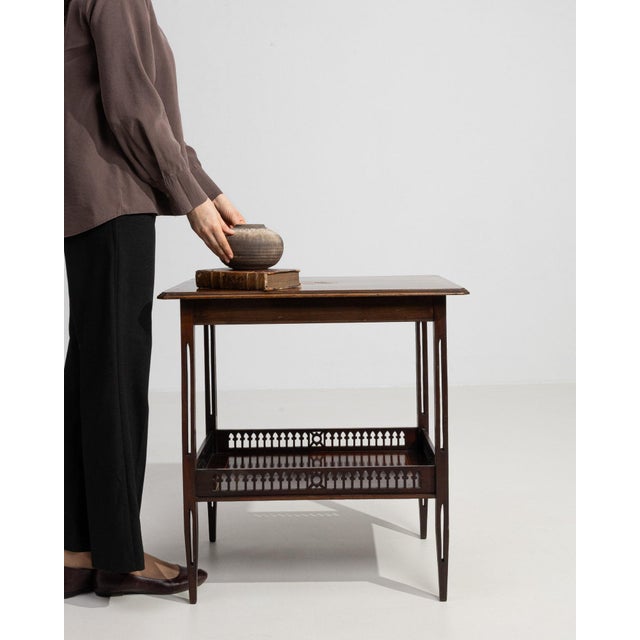 Caned-shelf walnut side table in Rich Walnut Brown. Its rich walnut brown finish sets off woven cane lower shelf, turned...