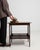Caned-shelf walnut side table in Rich Walnut Brown. Its rich walnut brown finish sets off woven cane lower shelf, turned...