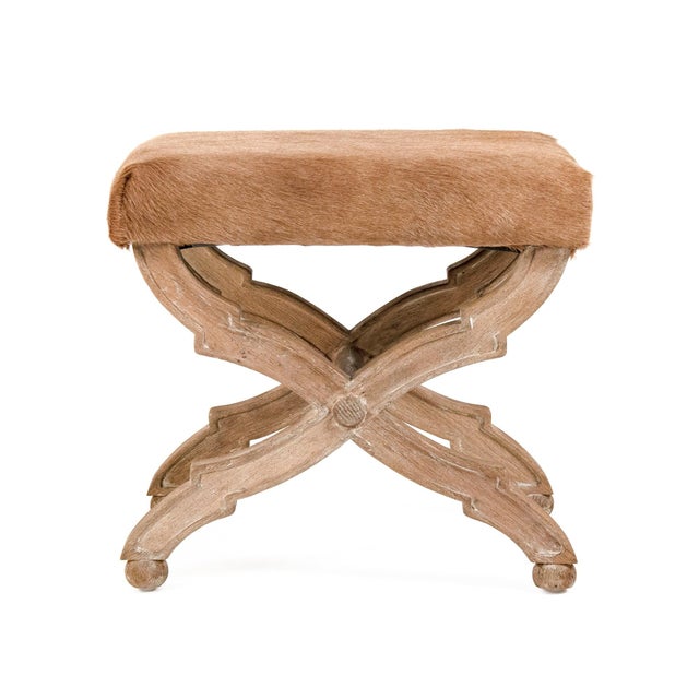 This is a stylish stool featuring a cowhide upholstered seat and a solid oak wood frame. The natural cowhide upholstery...